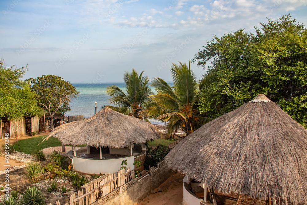 Beautiful morning view on the Indian ocean and the beach from balcony over the hut-tops, perfect way to start the day. Shore of Mozambique Beautiful morning view on the Indian ocean and the beach from balcony over the hut-tops, perfect way to start the day. Shore of Mozambique