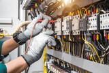 Electricity and electrical maintenance service, Engineer hand checking electric current voltage at circuit breaker terminal and cable wiring in main power distribution board.