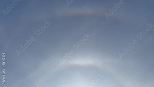 Blue sky with Halo around the sun - optical phenomenon. Circumzenithal arc, supralateral arc, upper tangent arc and sub parhelia on the clouds cirrostratus in the upper troposphere. photo