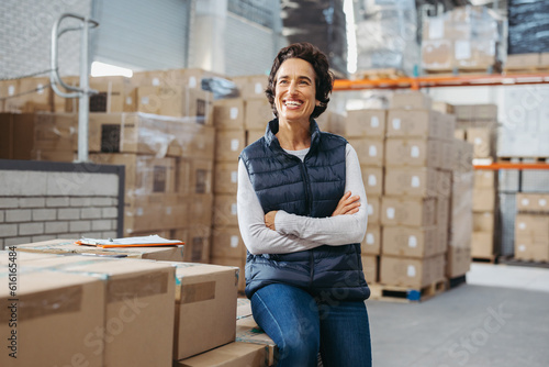 Cheerful warehouse manager looking away with a smile photo