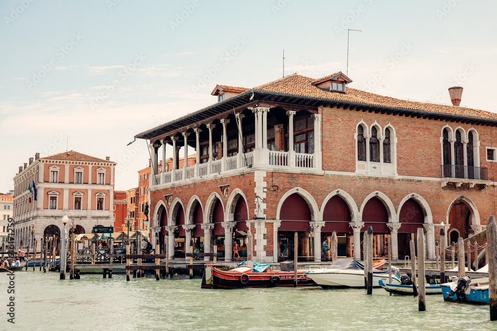 Quaint marketplace with an array of fruits and vegetables, located alongside Venice's majestic Grand Canal
