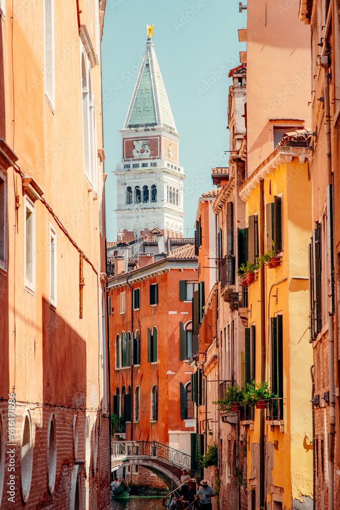 captivating beauty of Venice as you explore the canal that stretches towards the majestic St. Mark's Square Tower. Admire the picturesque waterway.
