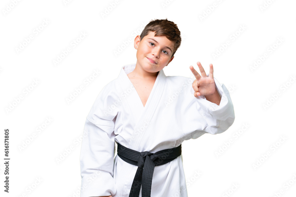 Little caucasian kid doing karate over isolated chroma key background happy and counting three with fingers Little caucasian kid doing karate over isolated chroma key background happy and counting three with fingers