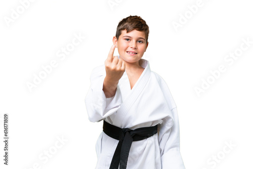 Little caucasian kid doing karate over isolated chroma key background doing coming gesture