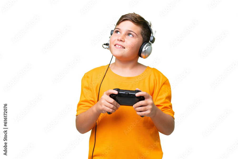 Little caucasian kid playing with a video game controller over isolated chroma key background thinking an idea while looking up Little caucasian kid playing with a video game controller over isolated chroma key background thinking an idea while looking up