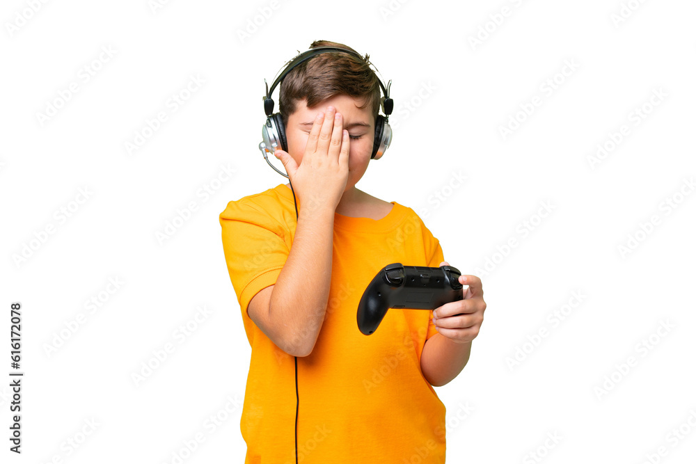 Little caucasian kid playing with a video game controller over isolated chroma key background with tired and sick expression Little caucasian kid playing with a video game controller over isolated chroma key background with tired and sick expression
