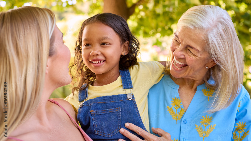 Portrait Of Smiling Multi-Generation Female Family In Garden Together Together Portrait Of Smiling Multi-Generation Female Family In Garden Together Together