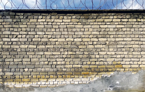 brick fence wall with barbed wire