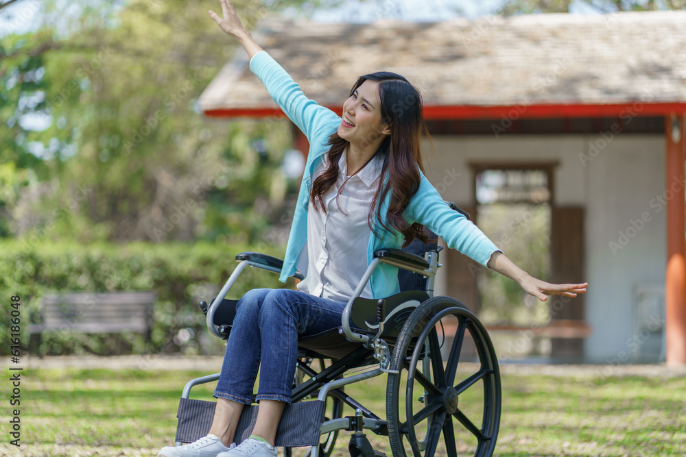 Obraz premium Young asian woman in wheelchair with positive thinking.