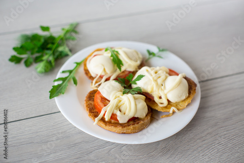 fried in batter sandwiches with tomatoes and mozzarella in a plate with herbs