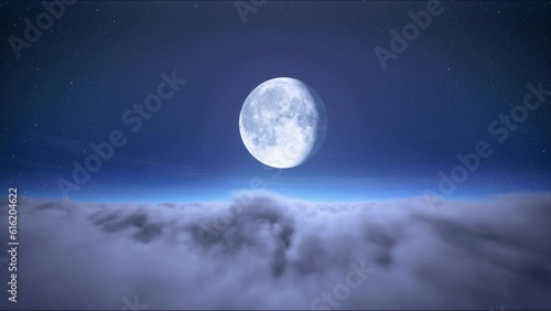 Timelapse of full moon on starry sky above moving clouds. The moon on cloudy sky. Christmas night background. Beautiful cloudscape 4k