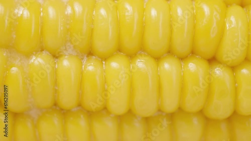 Melted butter and juice seeping through the cooked corn kernels. The shot is in macro, in slow motion. photo