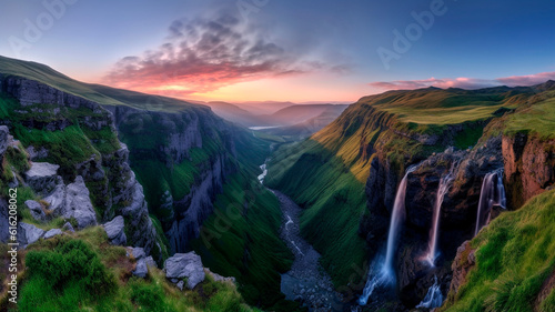 The waterfalls and mountains in a valley set against sunset 