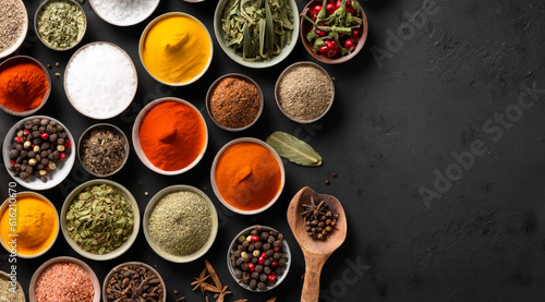 various colored spices on a dark table. space for copy.