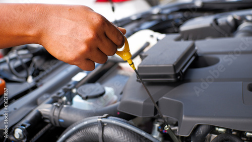 car mechanic checking car engine oil level and car engine oil quality