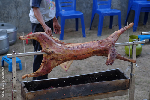 Kambing Guling or Grilled Goat, over hot coals and manually fanned.