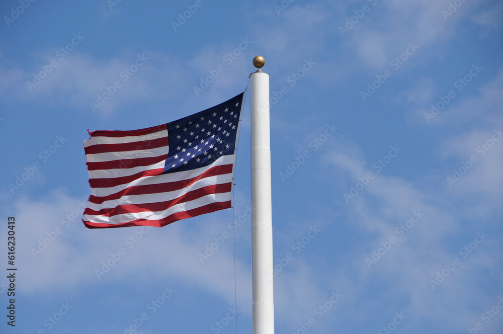 American Flag Waving In A Blue Sky American Flag Waving In A Blue Sky