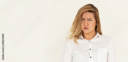 Fotografi Studio shot of cute girl with fair hair and confused face isolated on white back
