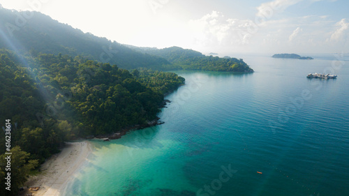 Aerial drone view of blue seaside by an island at Tinggi Island or Pulau Tinggi in Mersing, Johor, Malaysia