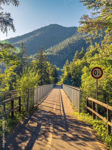 Bridge on the Alpe-Adria bicycle eurovelo way in Tarvisio, Italy during sunset