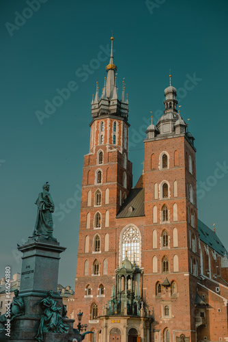 View of Saint Mary Basilica in Krakow, Poland on a summer sunny day viewed from the arcades at main city square.
