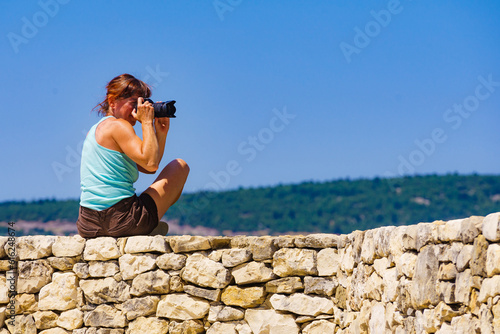 Woman take photo on mountain nature in France © Voyagerix