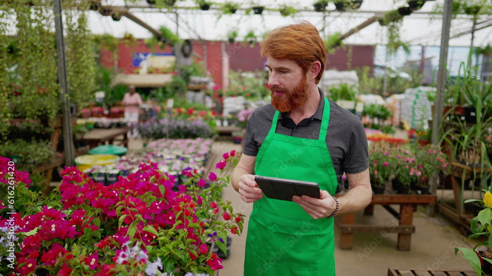 Green-Aproned Man Leveraging Tablet for Inventory in Flower Shop. Young Male Employee Engaging with Modern Tech Green-Aproned Man Leveraging Tablet for Inventory in Flower Shop. Young Male Employee Engaging with Modern Tech