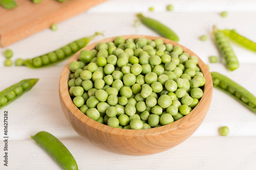 Composition with fresh green peas on wooden table Composition with fresh green peas on wooden table