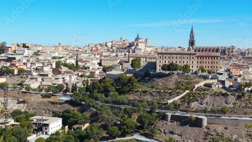 Panorama of the ancient city of Toledo on the banks of the Tagus River on a sunny day against the blue sky. Capital of the province of Toledo and  autonomous community of Castilla–La Mancha, Spain. 4K photo