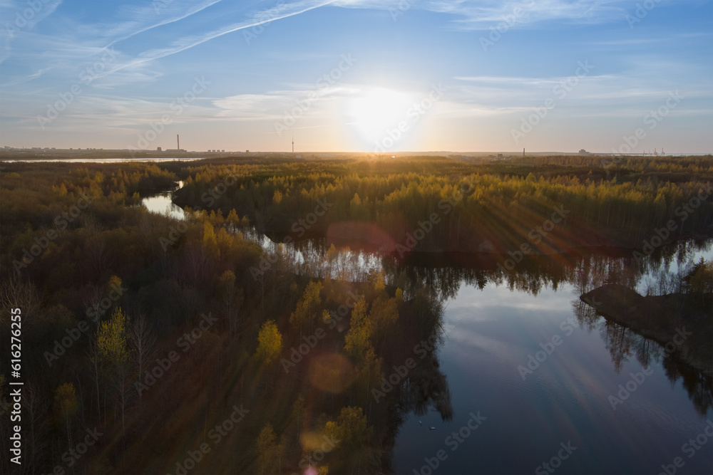 Beautiful sunset on a forest river in summer, view from a height.