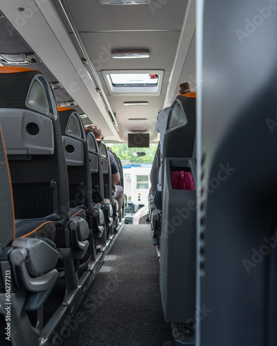 Inside the interior of a bus with rows of passenger seats, bus tourist travel, vertical shot