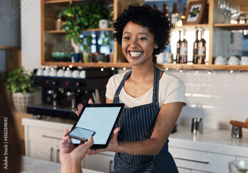 Happy woman, tablet and mockup screen for payment, ecommerce or tap in electronic purchase at cafe. Female waitress and customer with technology display for fintech transaction or paying at checkout photo