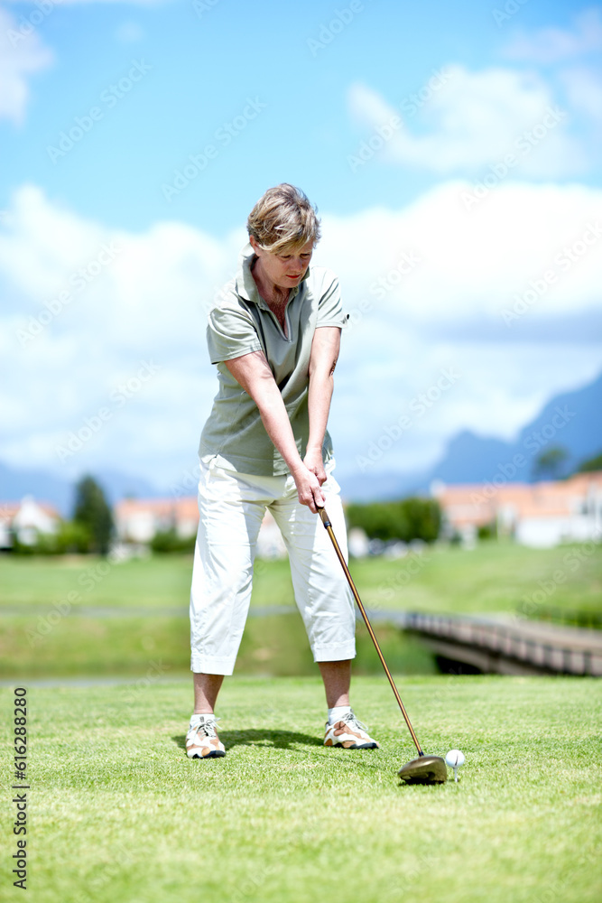 Senior, woman or golfer playing golf for fitness, workout or stroke exercise on a course in retirement. Mature, golfing or serious lady player training in sports game driving with her club or driver Senior, woman or golfer playing golf for fitness, workout or stroke exercise on a course in retirement. Mature, golfing or serious lady player training in sports game driving with her club or driver