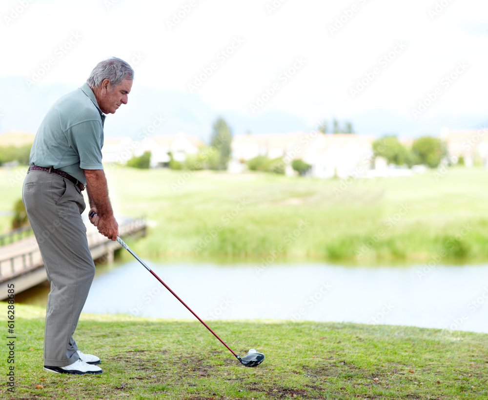 Fototapeta premium Senior, man or golfer playing golf for fitness, workout or exercise with a swing on a green course. Stroke, person golfing or mature player training in sports game driving with a club in retirement