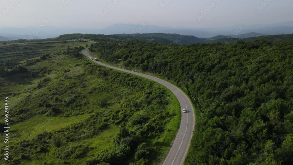 Aerial Drone View Car Driving on Curvy Mountain asphalt Road in summer Aerial Drone View Car Driving on Curvy Mountain asphalt Road in summer