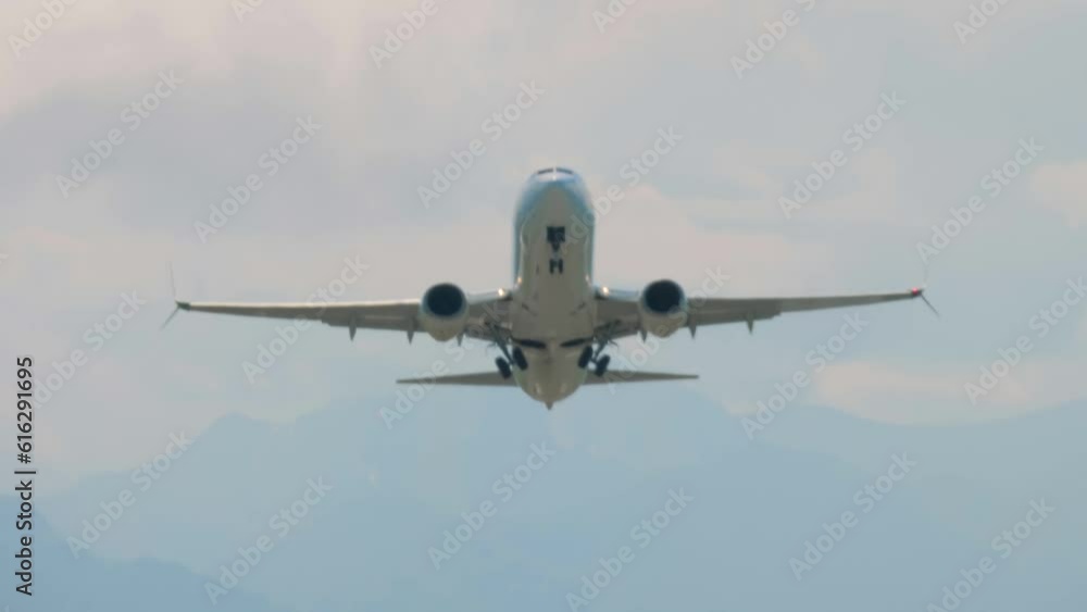 Passenger airplane, airliner is taking off, gaining altitude and flying in the cloudy sky - front view. Transportation, departure, journey, flight and tourism concept Passenger airplane, airliner is taking off, gaining altitude and flying in the cloudy sky - front view. Transportation, departure, journey, flight and tourism concept