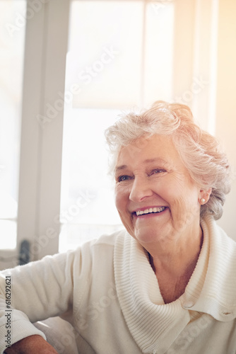 Relax, happy and face of old woman on sofa for free time, retirement and weekend. Smile, happiness and mindset with senior person in living room for elderly, positive and carefree resting at home