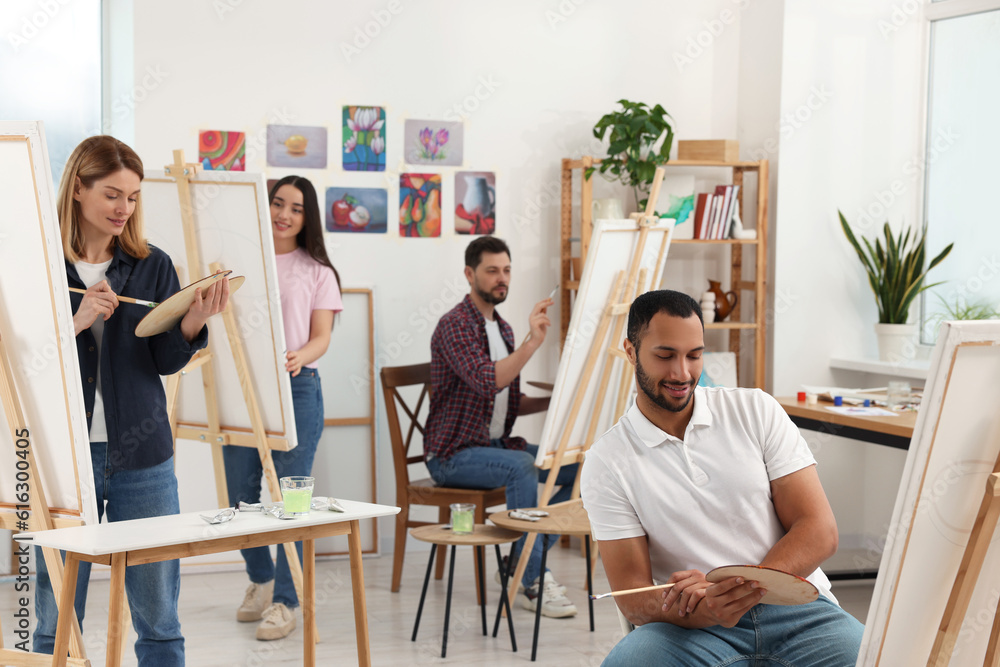 Group of students attending painting class in studio. Creative hobby Group of students attending painting class in studio. Creative hobby
