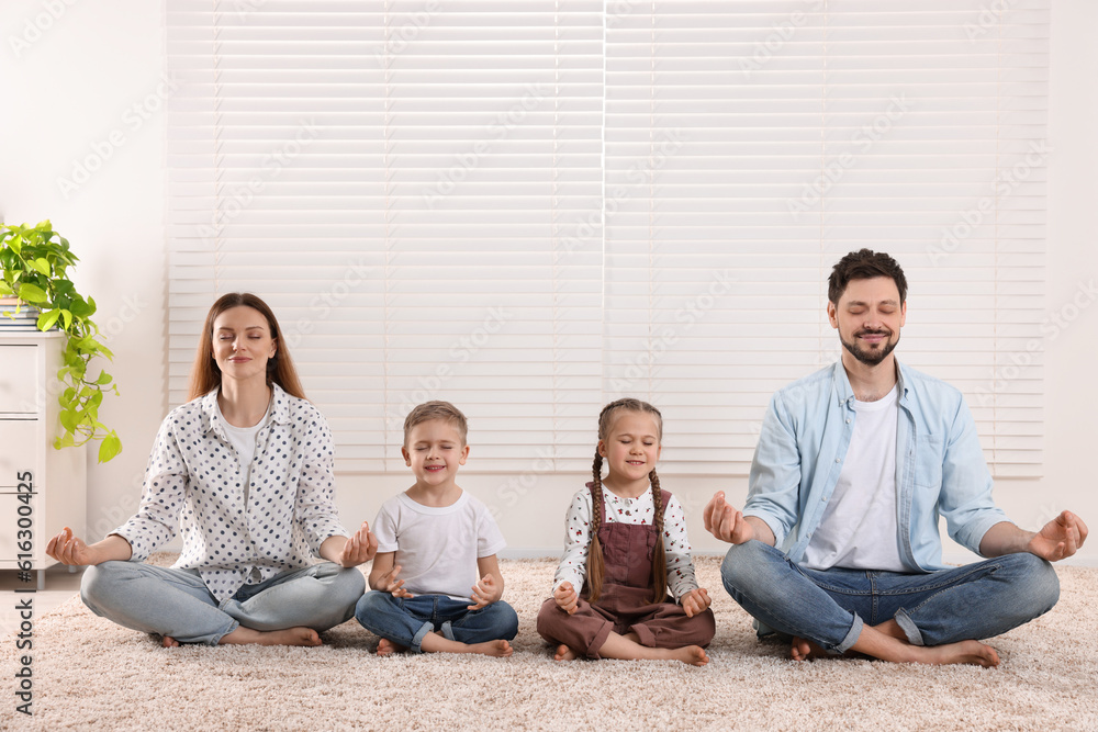 Family meditating together at home. Harmony and zen Family meditating together at home. Harmony and zen