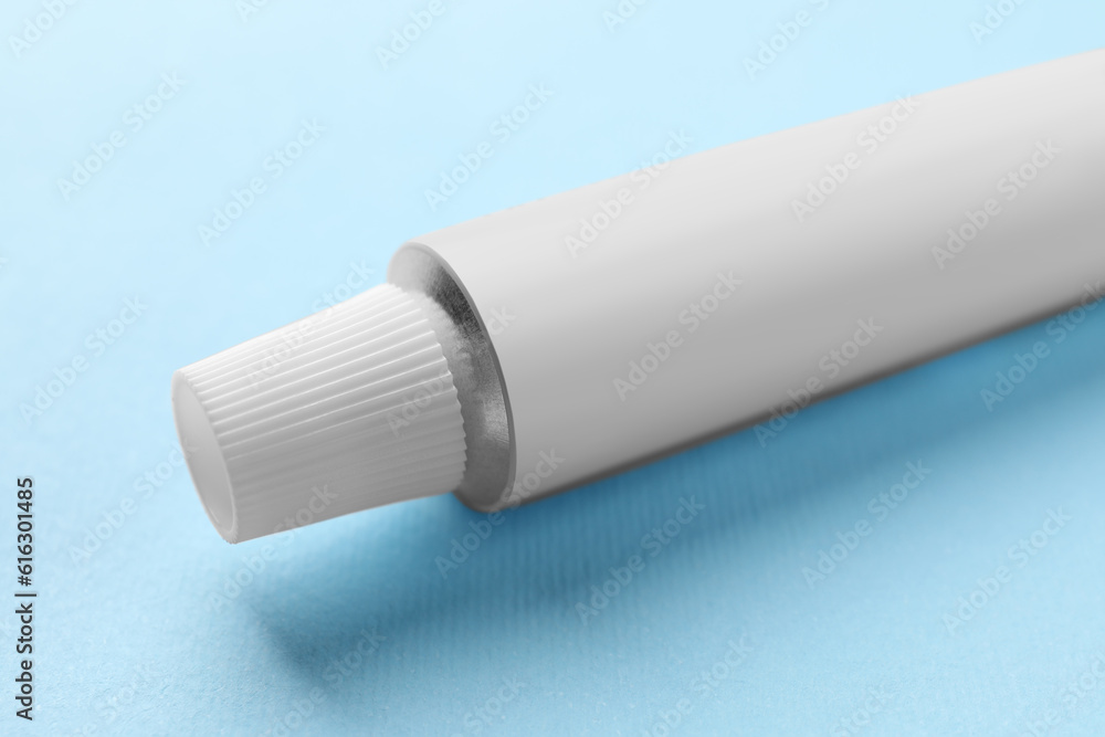 Tube of ointment on light blue background, space for text Tube of ointment on light blue background, space for text