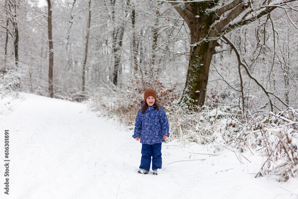 Adorable little girl having fun in beautiful winter park. Cute child playing outdoors. Winter activities for kids. Adorable little girl having fun in beautiful winter park. Cute child playing outdoors. Winter activities for kids.