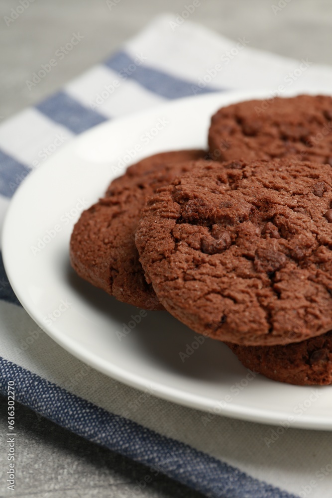 Delicious chocolate chip cookies on light grey table, closeup Delicious chocolate chip cookies on light grey table, closeup