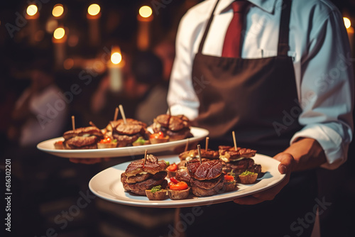 closeup photo of Waiter carrying plates with meat dish on some festive event, party or wedding reception restaurant