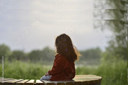 little girl playing and having fun by the river