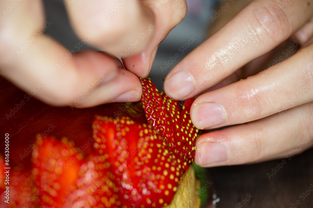 Close up shot of strawberries being placed on a cake. Close up shot of strawberries being placed on a cake.