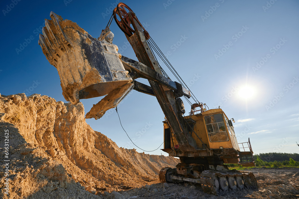 Shovel mining excavator operates in large open chalk quarry