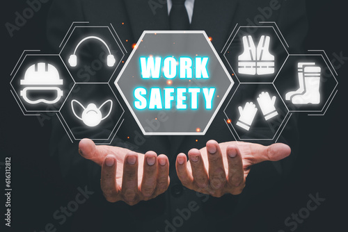 Work safety concept, Businessman hand holding holographic VR screen work safety icon, First secure rules. Health protection, personal security people on job.