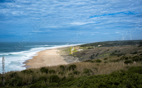 Nazare seascape with wave  beach and wind turbine