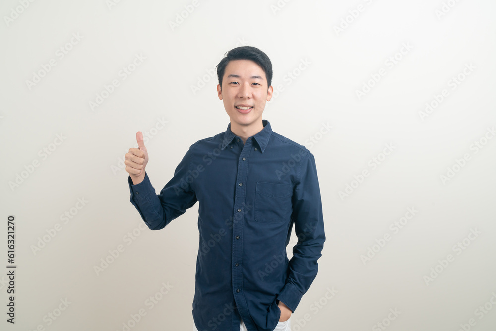 young Asian man thumbs up or ok hand sign young Asian man thumbs up or ok hand sign