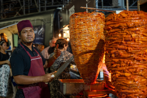 taquero preparando tacos al pastor photo